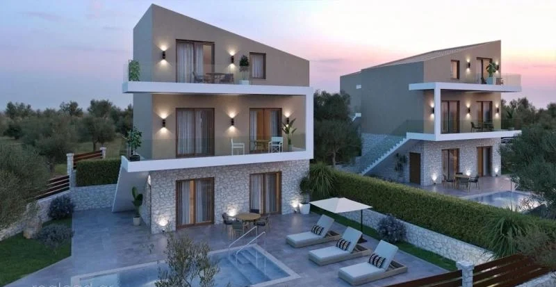 Modern villa in Nidri Lefkada with illuminated façade and private terrace at sunset