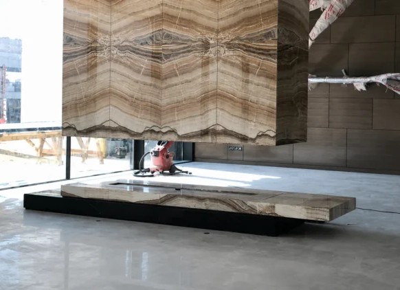 Custom-designed natural stone fireplace as the architectural centrepiece of the main living area